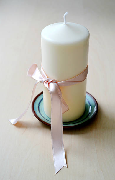 istock Unused big white candle with bright ribbon 504398963