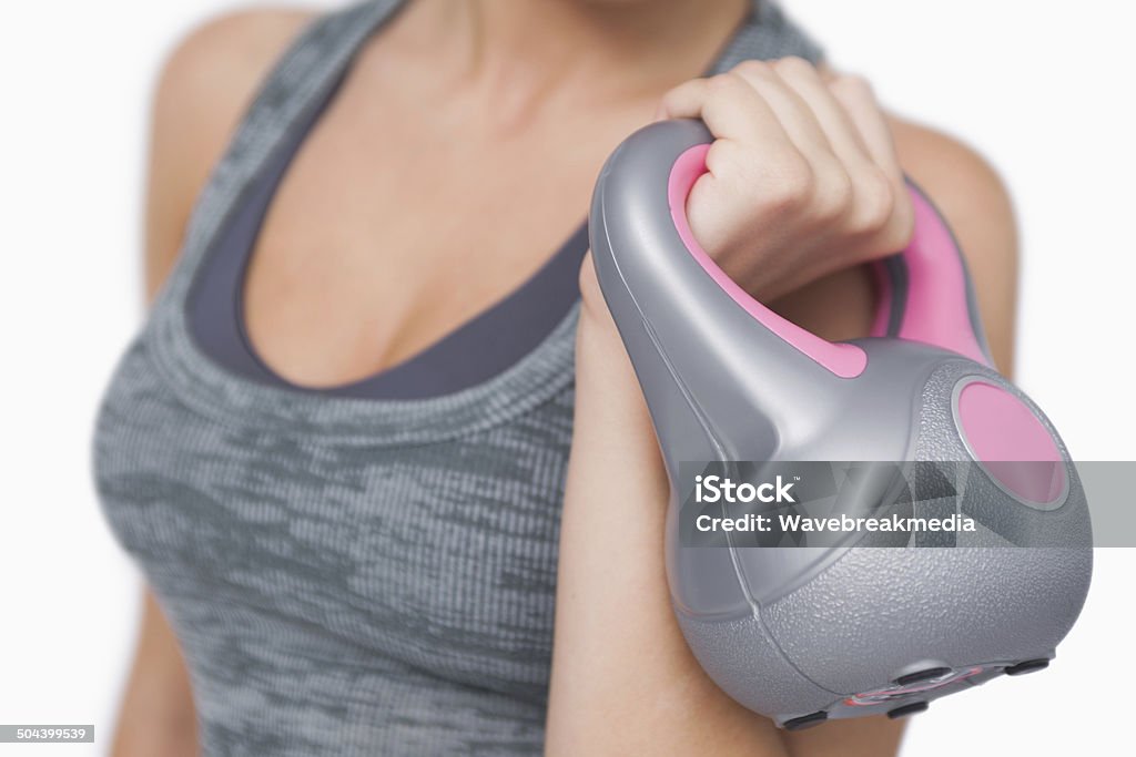 Close up of young woman training with kettle bell Close up of young woman training with kettle bell on white screen Adult Stock Photo