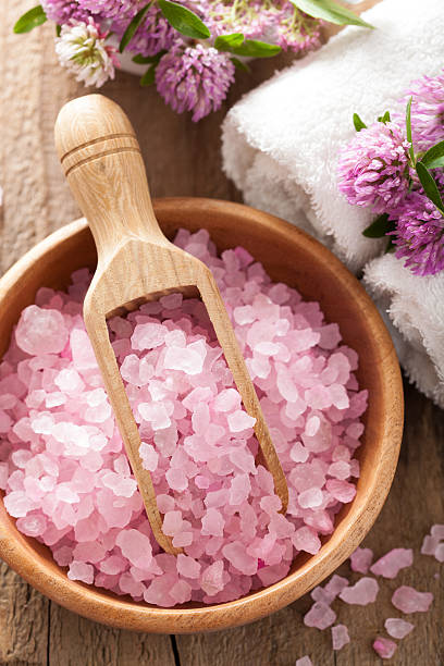 istock spa with pink herbal salt and clover flowers 504400451