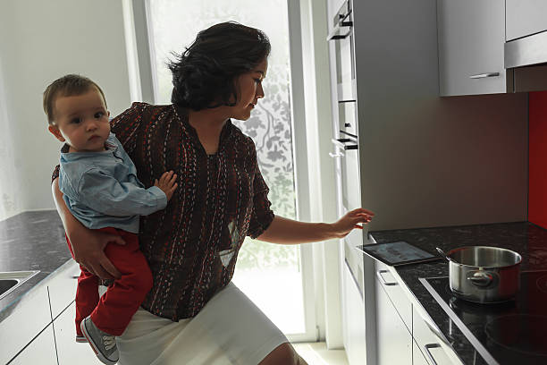 istock Mother holding baby on hip while reading tablet 504402159