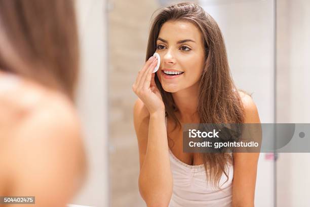 Beautiful Brunette Woman Removing Makeup From Her Face Stock Photo - Download Image Now