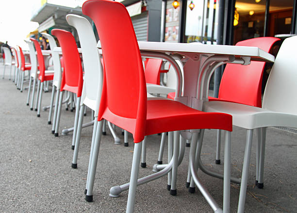 istock Red and white chairs with tables in an cafe 504404673