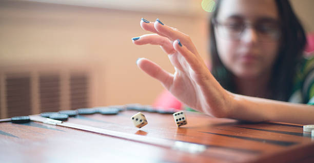 istock Teenager girl playing backgammon 504414452