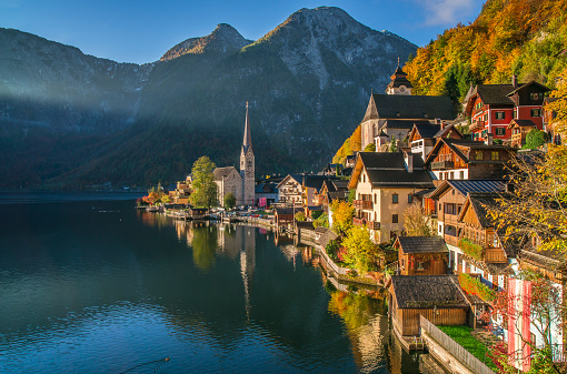 Scenic picture-postcard view of famous Hallstatt mountain village with Hallstatter See in the Austrian Alps in beautiful golden morning light in fall, region of Salzkammergut, Austria