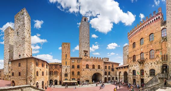 Panoramic view of famous Piazza del Duomo in the historic town of  San Gimignano on a sunny day, Tuscany, Italy