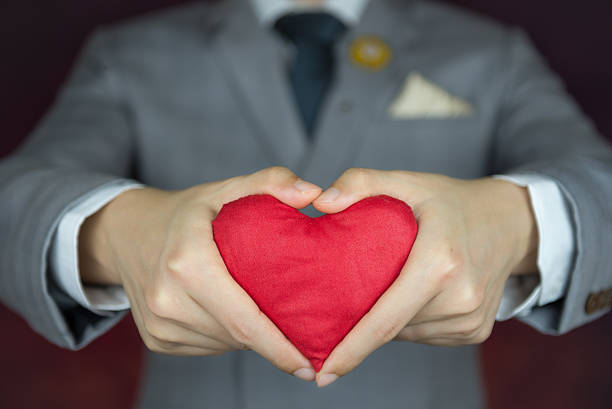 istock valentine's day concept,  man carries red heart 504418628