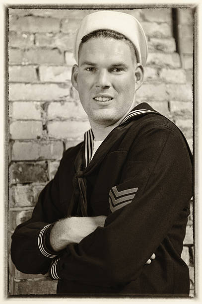 WWII US Navy Sailor - Aged Portrait Aged portrait of a  WWII US Navy Sailor.  Arms Crossed, smile on his face and that special look only a seaman has. us sailor stock pictures, royalty-free photos & images