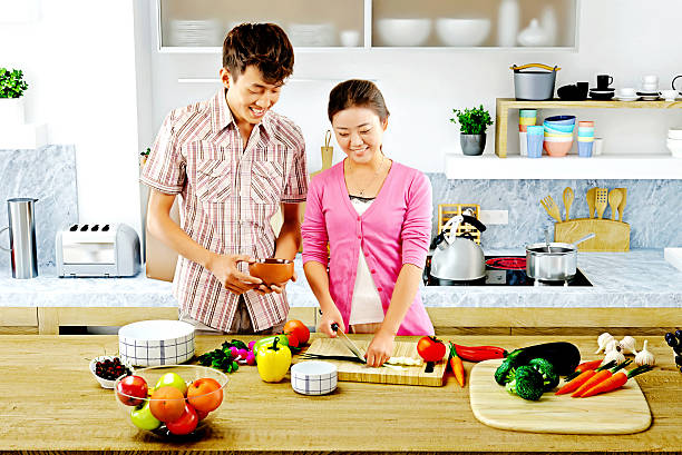 istock Young couple cooking - In the kitchen preparing food 504419436