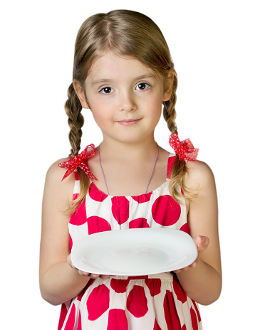 Child girl in red dress hold white empty dish isolated.Female caucasian kid stand with plate.Space for food.