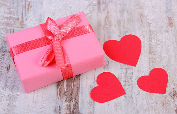 istock Wrapped gift for birthday, valentine or other celebration and hearts 504422596