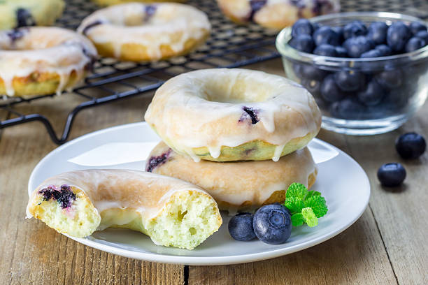 istock Freshly baked doughnuts with blueberries and lemon glaze, for breakfast 504422634