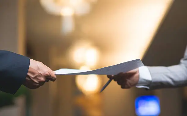 Hands of business people passing important document