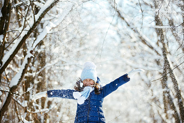 istock Little girl playing with a snowman 504423500