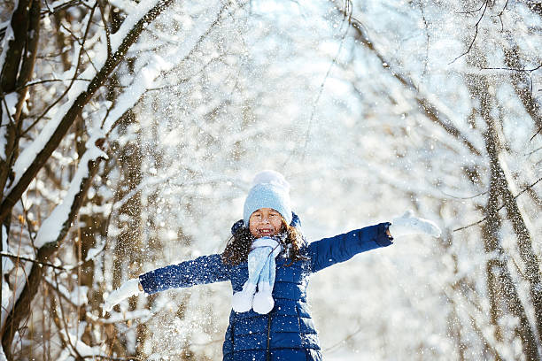 istock Little girl playing with a snowman 504423540