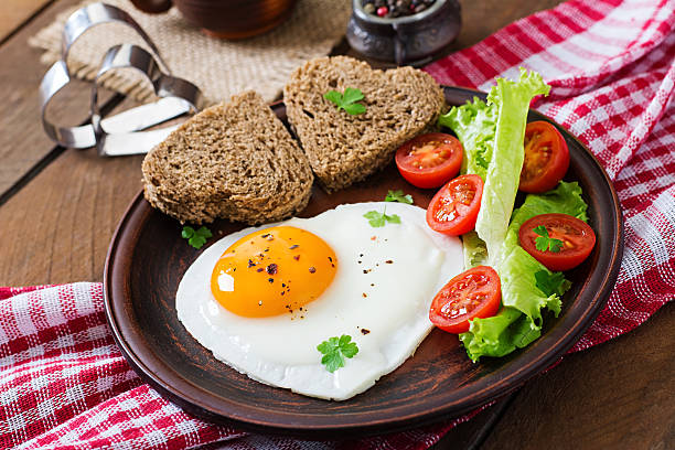 istock Breakfast on Valentine's Day - fried eggs and bread i 504423944