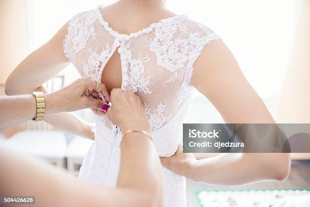 Putting On Wedding Dress Stock Photo - Download Image Now - Bride, Getting Dressed, Mother
