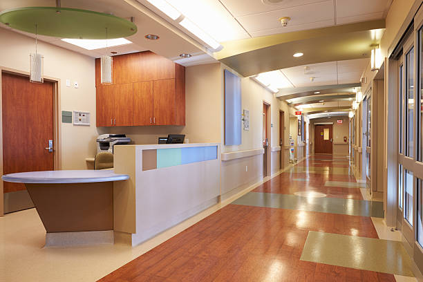 Empty Nurses Station And Corridor In Modern Hospital Empty Nurses Station And Corridor In Modern Hospital medical building stock pictures, royalty-free photos & images