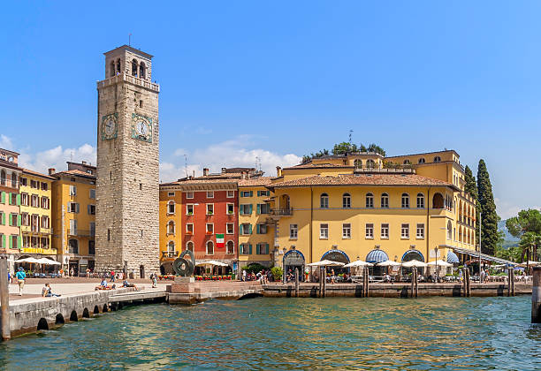 Riva Del Garda's quayside and town square bustles with tourists and locals on a bright sunny summers day