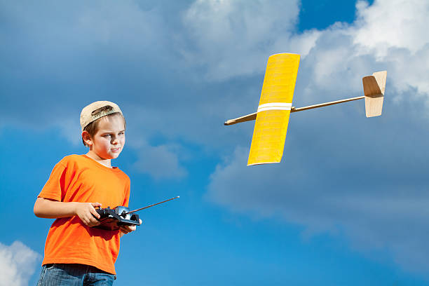 istock Little boy playing with handmade RC airplane toy 504445814