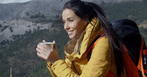 istock Young woman backpacker enjoying coffee 504446082