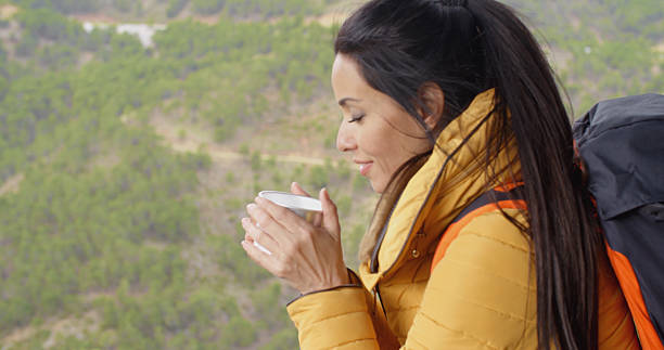 istock Young woman backpacker savoring her coffee 504446234