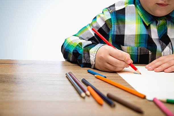 istock Close up of boy drawing with crayons 504446416