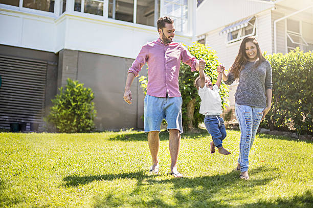 istock Parents playing with their son in garden 504446532