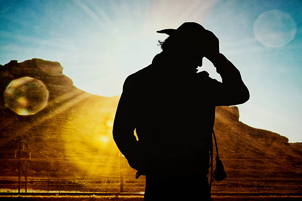 istock Cowboy standing in front of hill 504447420