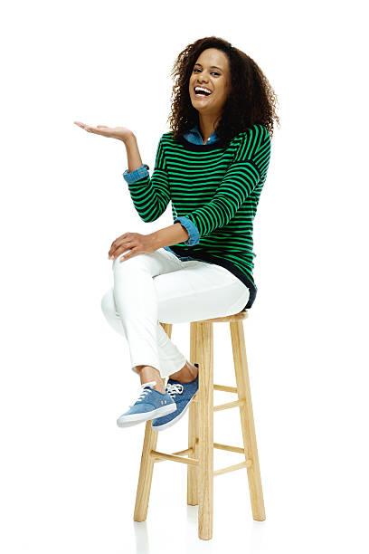 istock Cheerful woman on stool and presenting 504448554