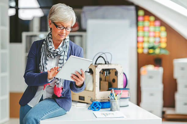 istock Mature Woman Working By 3D Printer 504450028