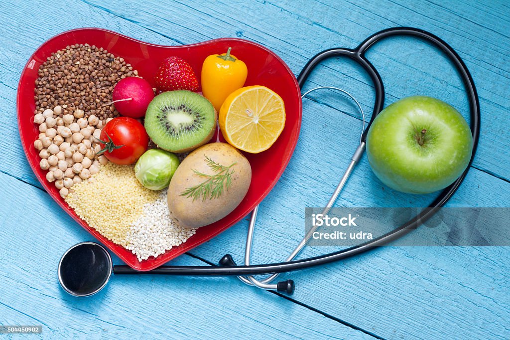 Food on heart plate with stethoscope Food on heart plate with stethoscope cardiology concept Cholesterol Stock Photo