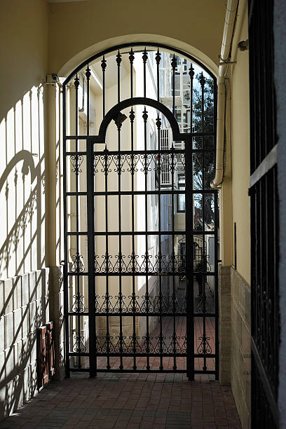 istock Iron Fence Door With Sunlight And Shadows 504451982