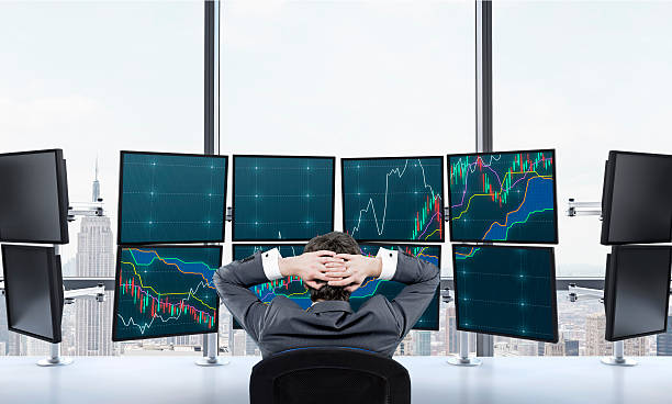 istock Ttrader at rest in front of screens 504453698