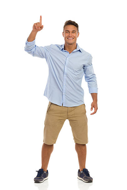 istock Smiling Attractive Male Pointing Up 504454404