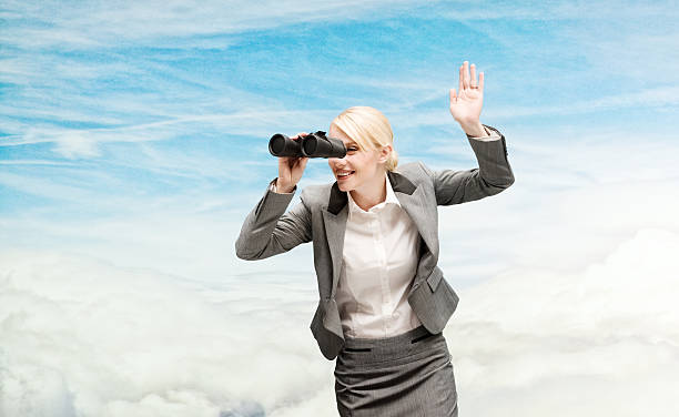 istock Businesswoman looking through binocular 504459012