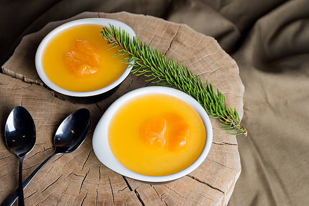 istock Panna cotta with tangerines served over gray textile. Top view. 504476504