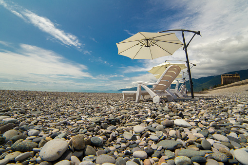 Beach umbrellas and chaise-lounges on the beach
