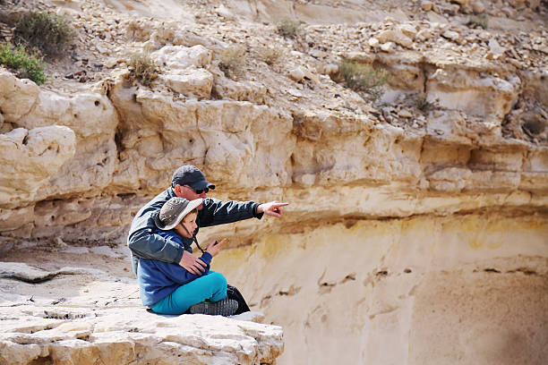 father and son father and son hiking together in the desert disabled person hiking outdoors stock pictures, royalty-free photos & images