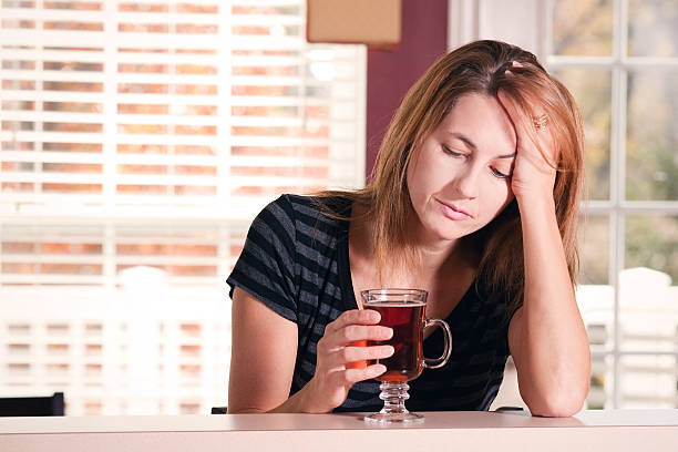 istock Sad Woman Holding Tea Cup 504480870