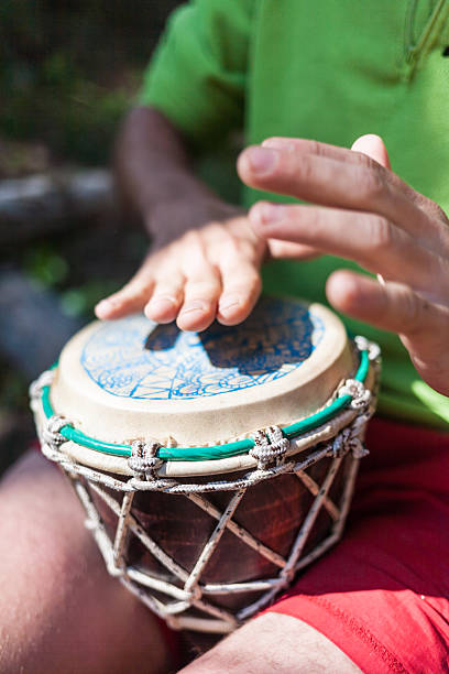 istock Man playing the hand drums in nature 504481607