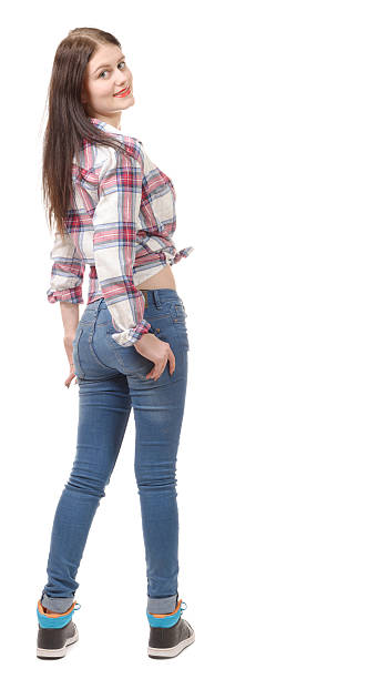 istock pretty young woman standing on white background, back view 504481704