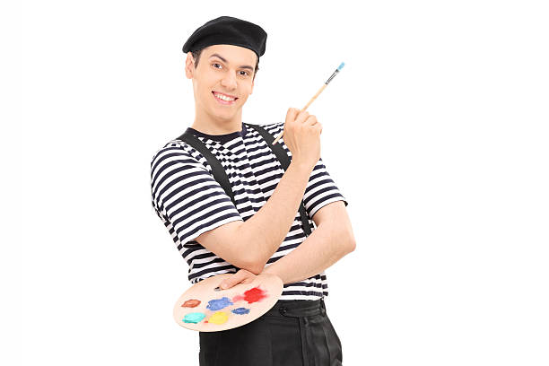 istock Male painter holding paintbrush and leaning against a wall 504482063