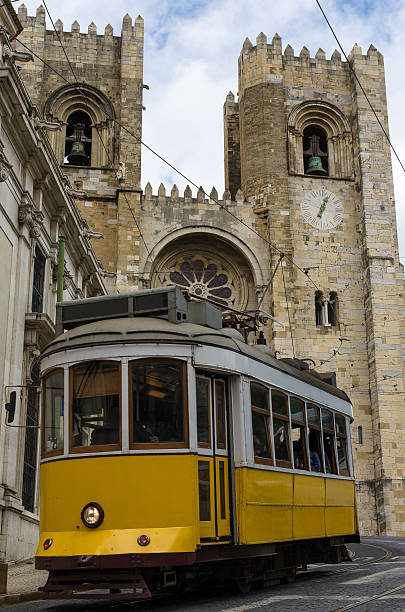 Lisbon cathedral and a yellow tramway stock photo