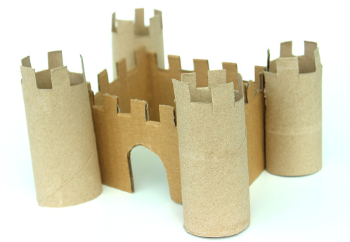 Photo showing a simple cardboard toy castle made with cereal boxes and  toilet rolls, made by a child for her school homework project.