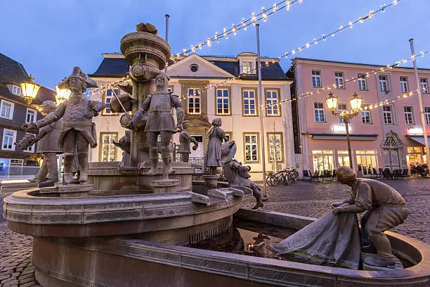 historic fountain on the townhall place lippstadt germany in the evening