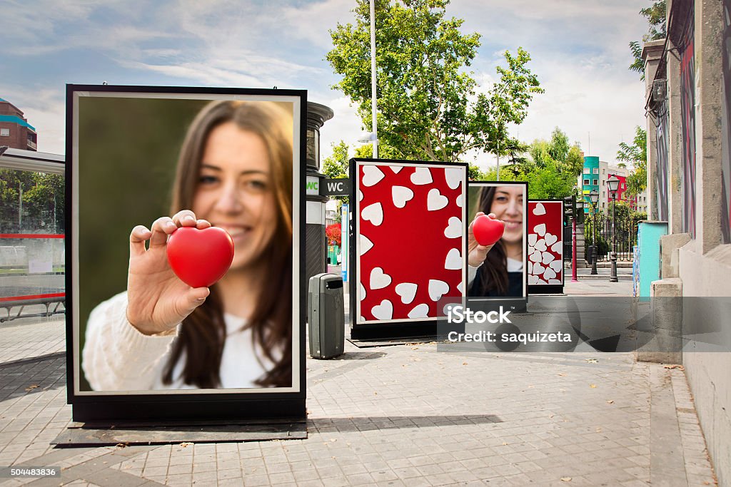 Love billboards, photographs of a woman with red heart Love billboards, photographs of a woman with red heart, at city street in valentineÂ´s day Advertisement Stock Photo
