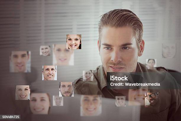 Hombre Atractivo Rodeado De Molduras Con Interfaz Digital Foto de stock y más banco de imágenes de Dispositivo de pantalla