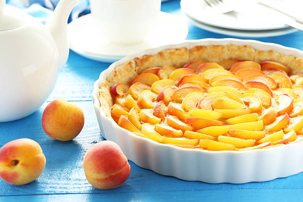 istock Apricot pie on blue wooden background 504485170