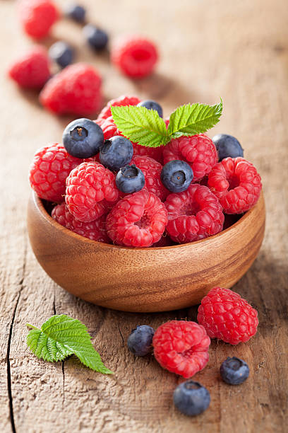 istock fresh berries raspberry blueberry in wooden bowl 504485329