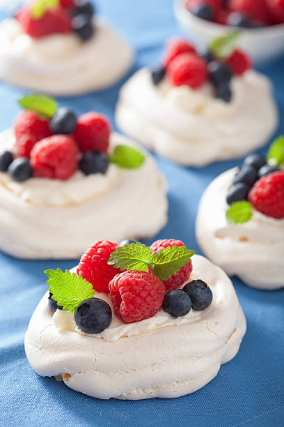istock pavlova meringue cake with cream and berry 504485337